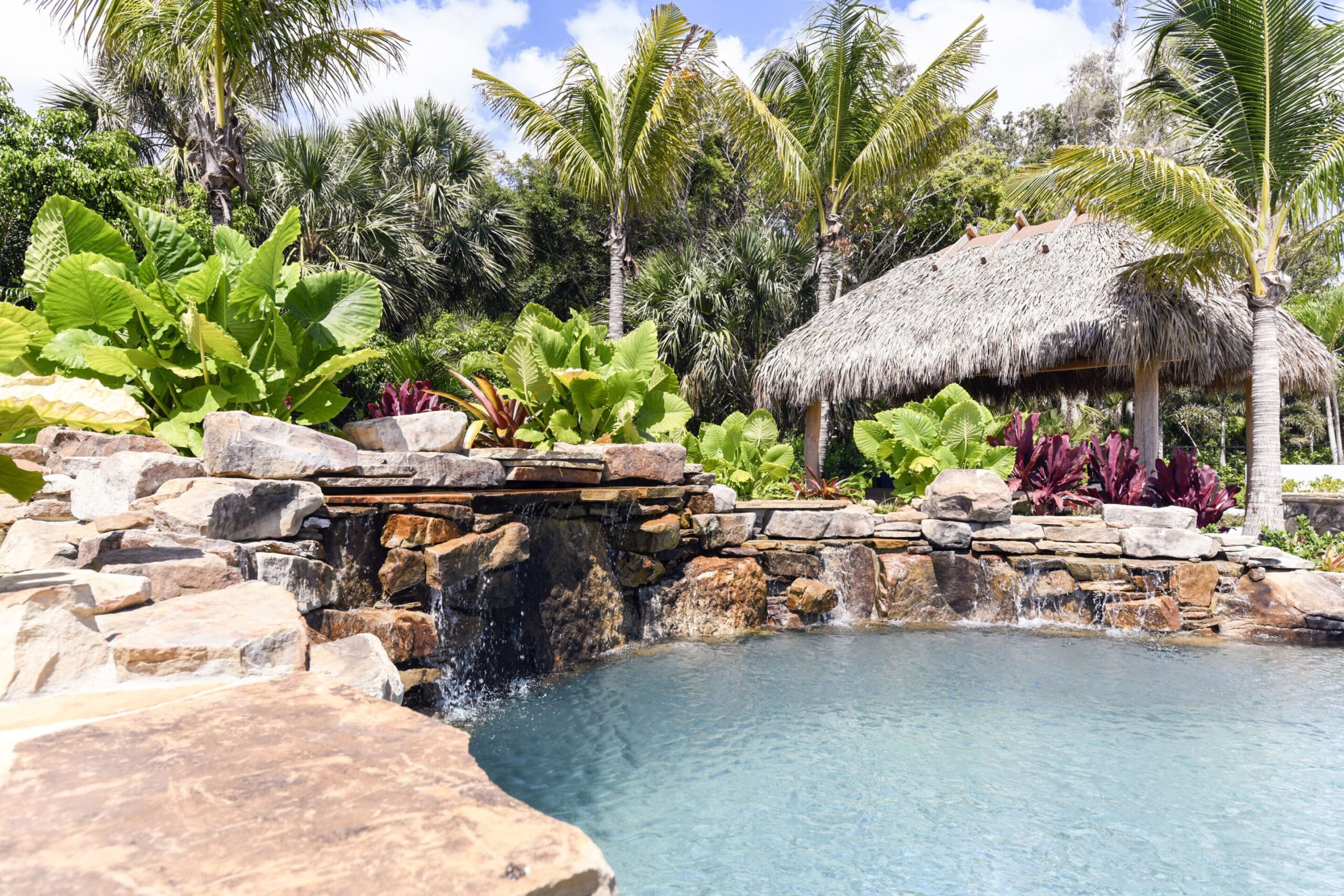 Custom pool with waterfall and rock design.